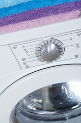 Washing machine , White washing machine with towels on top, close-up