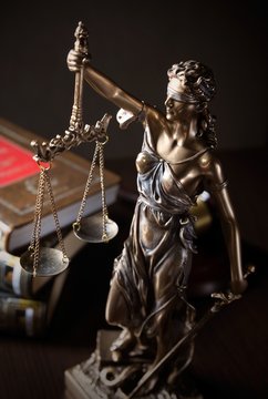Law concept with Themis and books in background