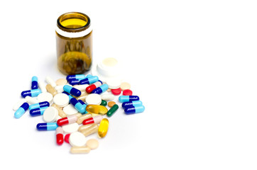 Empty bottle and the bunch of pills and drogs isolated on white.
