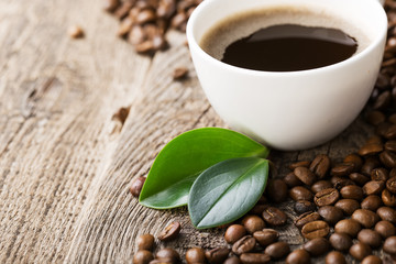 ground coffee in scoop and coffee beans on a wooden background,