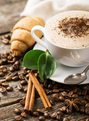 Hot coffee and pastries on a wooden background