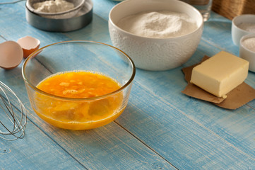 Beaten eggs with ingredients for preparing baked products