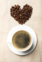 Heart of coffee beans on sacking, view from the top