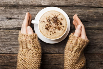 woman holding hot cup of coffee