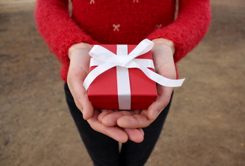 Girl holding a red gift box