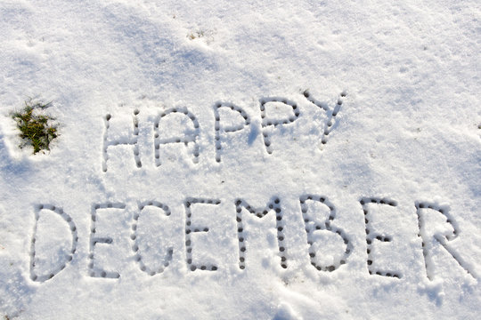 Written words Happy December on a snow field, filter applied