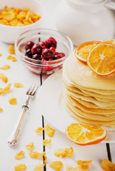 delicious pancakes on wooden table with fruits