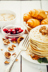 delicious pancakes on a wooden table with nuts