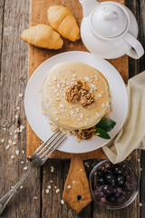 delicious pancakes on a wooden table with nuts