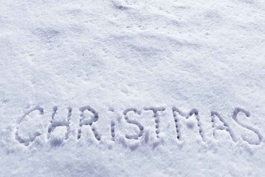 Written words Christmas on a snow field, new year concept, filter applied
