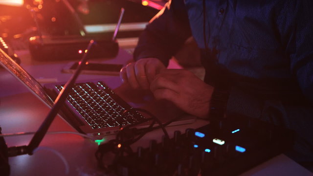  DJ works with Laptop. red light on background 2