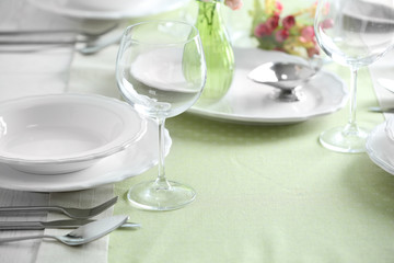 Table set at restaurant on light background