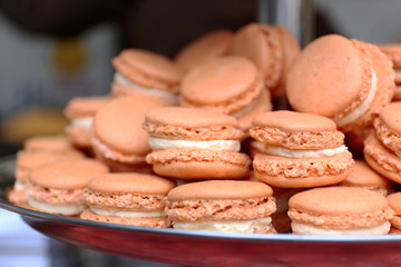 Beige macaroons on plate closeup
