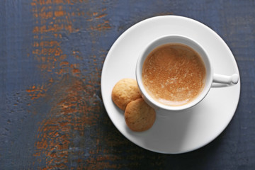 Cup of coffee on wooden table background