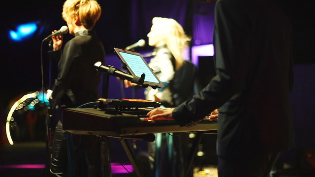 Pianist playing on the stage with tablet PC