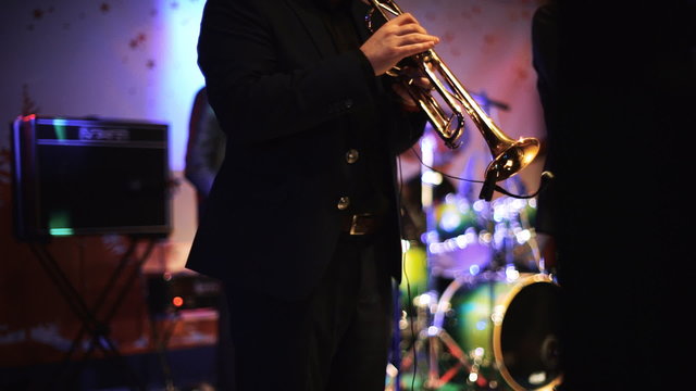 Two men playing on trumpets on the stage 2