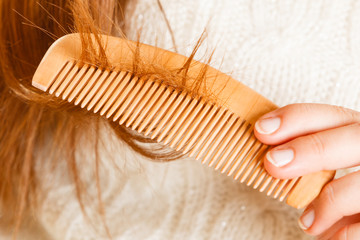 Female hand combing long hair.