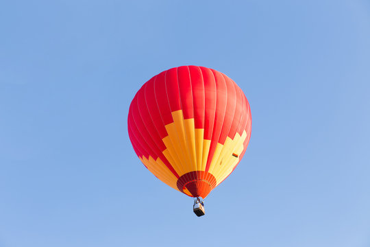 Red hot air balloon on blue sky