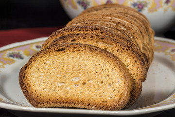 Slices of toasted wheat bread on a ceramic tray