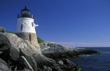 Fototapeta na wymiar Historic Castle Hill lighthouse is constructed on a rocky ledge near Newport, Rhode Island,