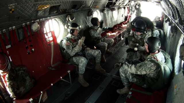 Footage from inside a CH-47 Chinook helicopter transporting paratroopers.