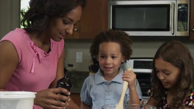 Slow motion of mother measuring vanilia.