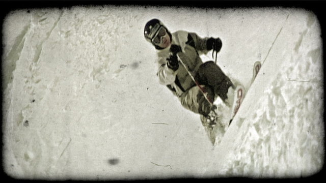 Man skis through powder. Vintage stylized video clip.