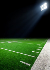 Fototapeta na wymiar Football field illuminated by stadium lights