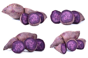 Whole purple yams photographed on a white background.