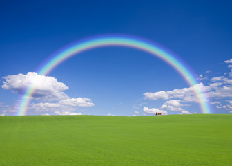 Red roof house on the hill with rainbow