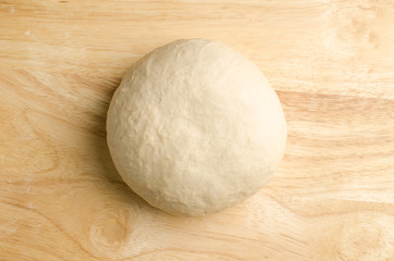Bread dough on wooden background