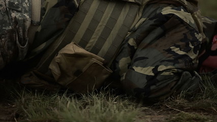 Soldier crawling in field