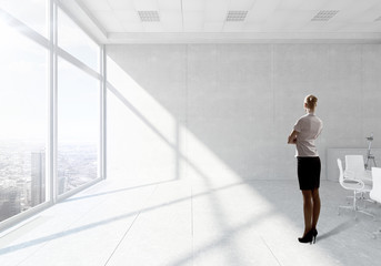 Fototapeta na wymiar Businesswoman in top floor office