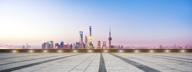 empty floor and cityscape in blue sky at dawn