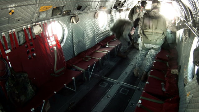 Paratroopers jumping out the back of a CH-47 Chinook helicopter.