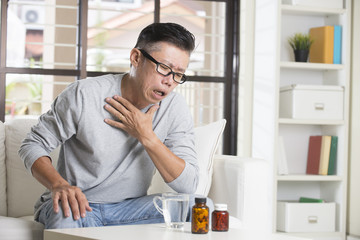 asian senior male in pain