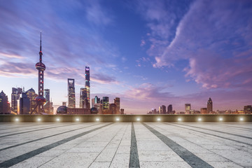 empty floor and cityscape in colorful sky at dawn