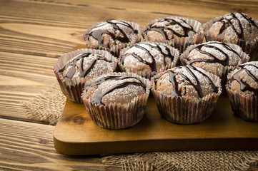 Chocolate muffins on the wooden board.