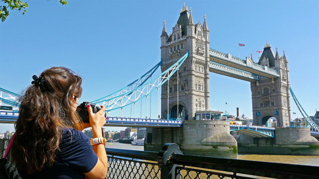 Woman photographer tourist taking photo on Tower Bridge