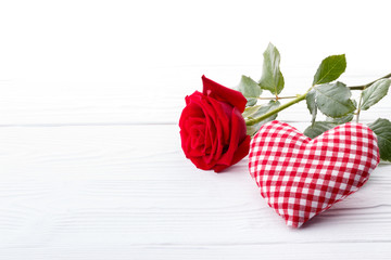 Red rose and a heart on white background