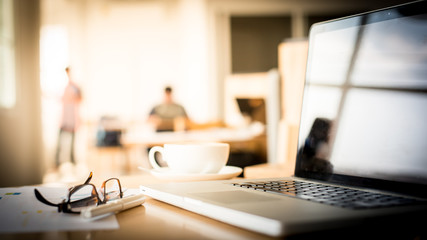 lose-up of workplace in modern office with business people behin