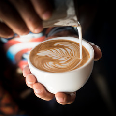 cup of coffee latte art in coffee shop vintage color tone