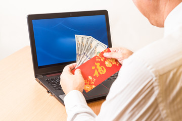 Employee displaying red packet with Good Fortune Chinese character, and money received during...