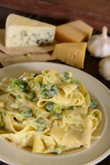Pappardelle pasta with four cheese sauce and broccoli