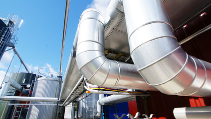 Industrial zone, Steel pipelines and valves against blue sky