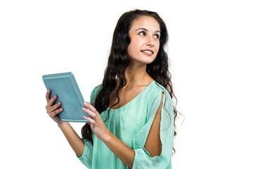 Smiling woman holding tablet and looking away