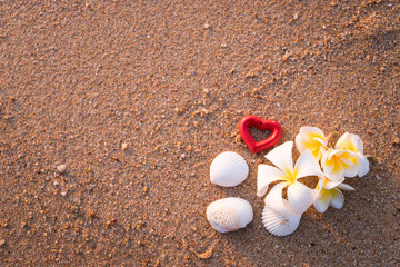 Group of frangipani, plumeria flowers, together with two red hea