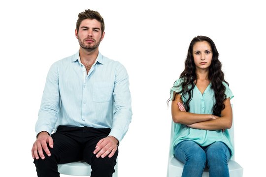 Couple sitting on chairs not talking after argument
