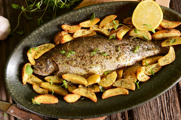 Roasted trout with potatoes in thyme