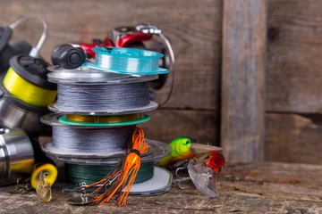 Foto op Aluminium sport fishing tackles, baits, reels, spool with line © sytnik